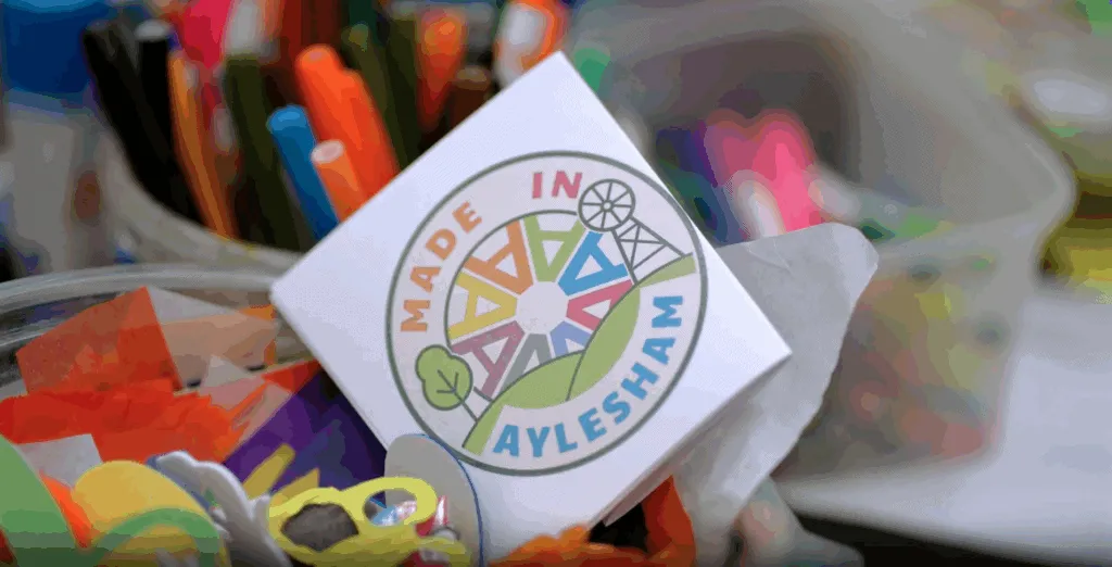 Colorful community project logo for Aylesham Community Trust, promoting local initiatives and environmental awareness in Aylesham. Focus on community engagement and local development.