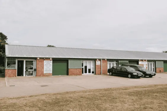 Modern community center building in Aylesham with parking, green shutters, and a welcoming entrance, serving as a hub for local events and activities.